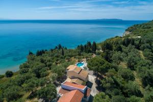 an aerial view of a house on a hill next to the ocean at The Gunnery House in Papoutsíras