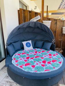 a blue bed with a colorful blanket on top of it at Arapya Beach Apartment in Tsarevo