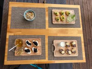 a table with three plates of food on it at Villa White in Ksamil