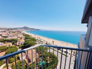 a view of the beach from the balcony of a condo at BRAVAHOLIDAYS-410-Neptuno in Blanes