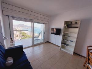 a living room with a view of the ocean at BRAVAHOLIDAYS-410-Neptuno in Blanes