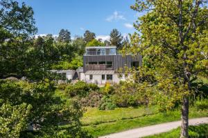 a house on a hill with trees at 4 Bedroom Archipelago Retreat in Tranholmen