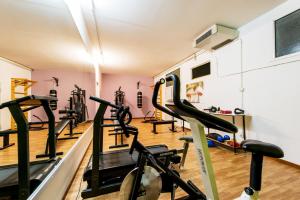 a gym with treadmills and ellipticals in a room at Hotel Villa Truentum in Martinsicuro