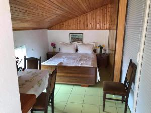 1 dormitorio con 1 cama, mesa y sillas en слънце en Shabla