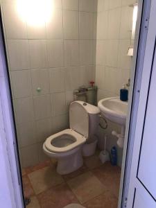 a bathroom with a toilet and a sink at слънце in Shabla