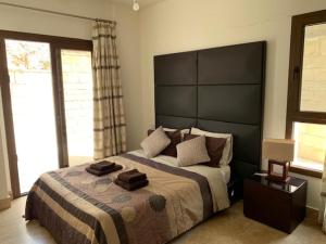 a bedroom with a large bed with a large headboard at Beau Views Seven in Peyia +28 photos