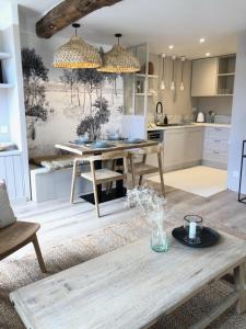 a living room with a table and a kitchen at MAISON NOMADE Valbonne in Valbonne