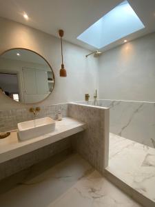 a bathroom with a sink and a mirror at MAISON NOMADE Valbonne in Valbonne