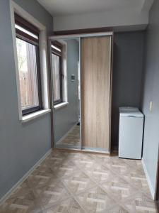 een lege kamer met een deur en een wasmachine en droger bij MAFA Apartaments in Boekovel