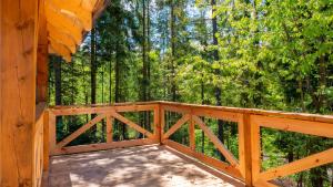 a wooden deck with trees in the background at Ostoja Rycerka in Rycerka Górna
