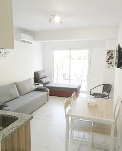 a living room with a couch and a table at Babylon Tourist Apartments in Benalmádena