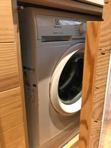 a washing machine in a cabinet in a kitchen at Chalet Monaci alla Fontana "Junior suite" in Albosaggia