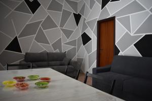a dining room with a table and two chairs at Zeropassidalcentro Zeroinfrominthecenter in Marsala
