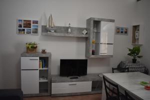 a living room with a television and a table at Zeropassidalcentro Zeroinfrominthecenter in Marsala +32 photos