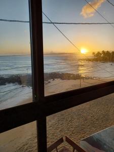 a view of the ocean from a window of a beach at SuRFCoRe House in Baía Formosa