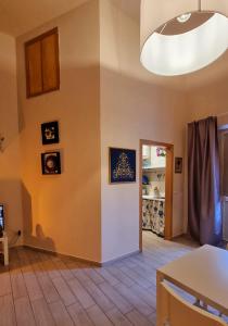 a living room with a table and a light fixture at Ercole' s Home in Caserta