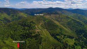 an aerial view of a forested mountain with a red arrow at Ostoja Rycerka in Rycerka Górna