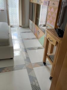 a room with a mirror and a tiled floor at Kussmann Appartment in Varna City