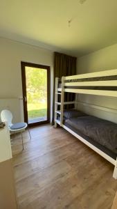 a bedroom with two bunk beds and a window at AUSZEIT in Obertal