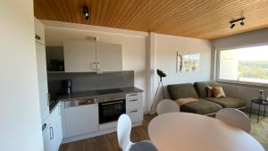a kitchen and living room with a couch and a table at AUSZEIT in Obertal