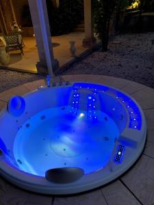 a blue jacuzzi tub sitting on a patio at Villa Rosina in Noto