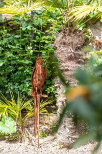 a brown bird sitting on a wooden pole at B&B Unterhabsbergerhof in Appiano sulla Strada del Vino