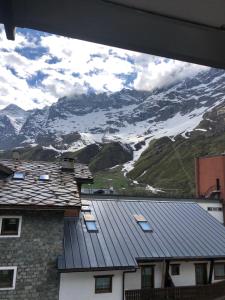 a view of a snow covered mountain from a house at Golf & SKI studio in Breuil-Cervinia
