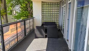 a balcony with two chairs on a porch at Apartamenty Przemko in Rewal