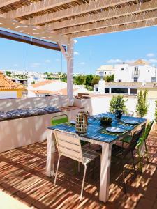 einen Tisch und Stühle auf einem Balkon mit Aussicht in der Unterkunft Casa Do Gilao in Tavira