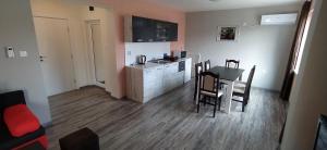 a kitchen and dining room with a table and chairs at Къща, стаи за гости Мери in Chernomorets