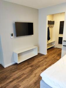 a living room with a flat screen tv on a wall at Apartment 401 in Bergün