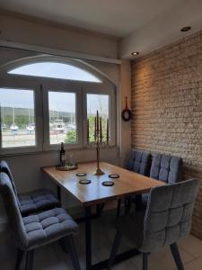 a dining room with a wooden table and chairs at Francesca Apartment in Bibinje