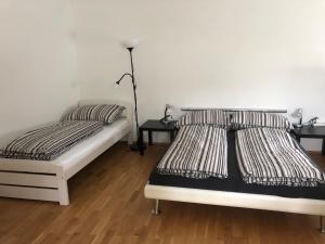 a bedroom with two beds and two night stands at City Apartment Railway in Klagenfurt