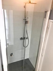 a shower with a glass door in a bathroom at Au COCON QUIMPEROIS in Quimper +43 photos