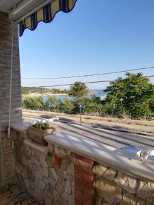 a stone wall with a view of a road at GIADA MARIA SOLE HOUSE in Pulsano