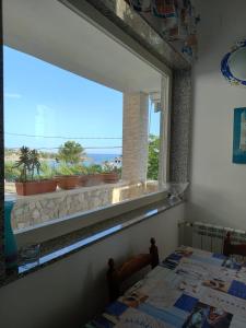 Schlafzimmer mit einem Fenster mit Meerblick in der Unterkunft GIADA MARIA SOLE HOUSE in Pulsano