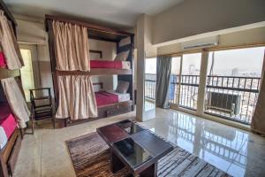 a room with two bunk beds and a balcony at Castle Hostel in Cairo