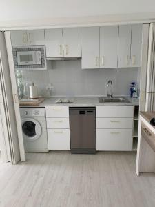 een witte keuken met een wastafel en een vaatwasser bij SALESAS OVIEDO CENTRO COMERCIAL CORTE NGLES- Apartamento in Oviedo