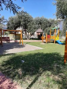 a park with a playground with a swing set at Perfect Apartment in Nea Potidaea
