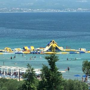 a water park with a water slide in the ocean at Perfect Apartment in Nea Potidaea