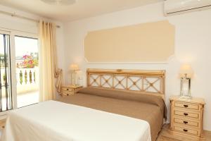 a bedroom with a white bed and a window at Holiday VILLA GOLF & SEE VIEW Villamartin in Orihuela Costa +80 photos