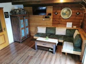 a living room with a couch and a table at Almhütte Kristabauer in Predlitz
