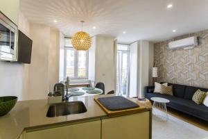 cocina y sala de estar con sofá y lavamanos en Prestige Ajuda Apartment en Lisboa