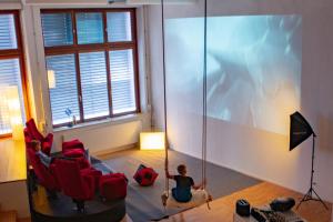 a child on a swing in a living room at Loft with Home Cinema in Triesenberg