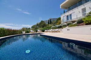 a swimming pool in front of a house at Villa Miramar by Glasir in Sitges