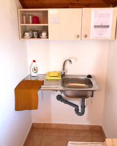 a stainless steel sink in a small kitchen at Vila Aliaj' lovely room for two with air condition and roof tarrace in Durrës