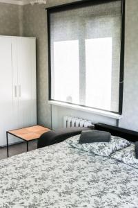 a bedroom with a bed and a large window at Centrum Apartement in Valga