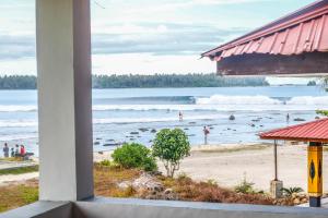 a view of the beach from a building at Nias Surf Stay in Lagudri