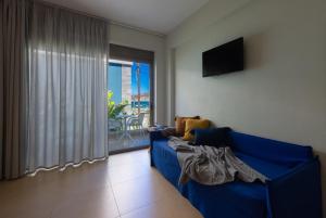 a blue couch in a living room with a window at Blue Horizon in Palaiochóra