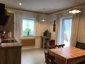 a kitchen and dining room with a table and a window at Landhaus Schönblick in Radenthein